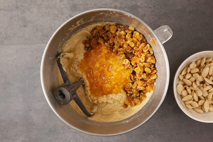 Beat in eggs, one at a time, until combined. Stir in orange marmalade, orange zest and soaked raisins until combined.