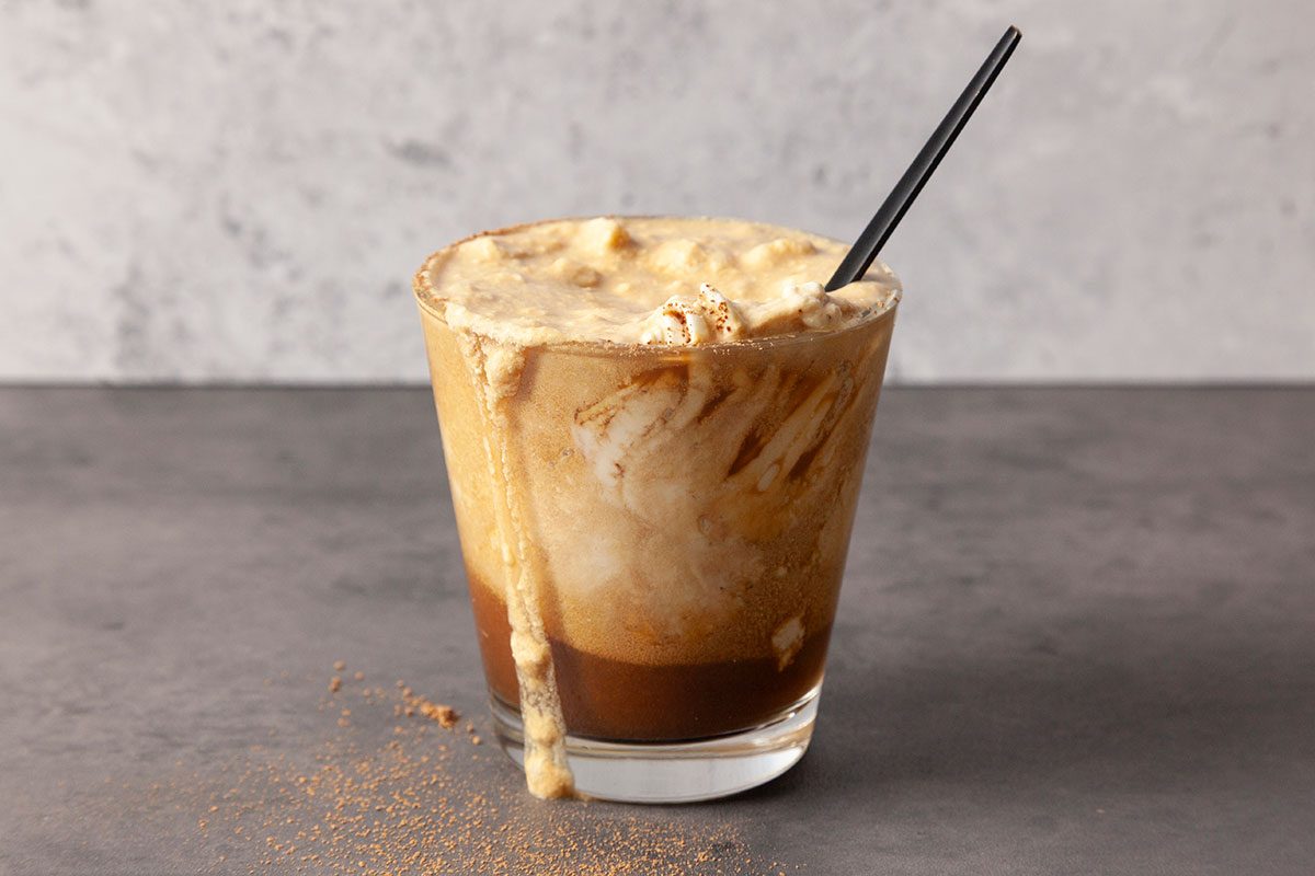 Einspanner Coffee in a mug with whipped cream stirred in.