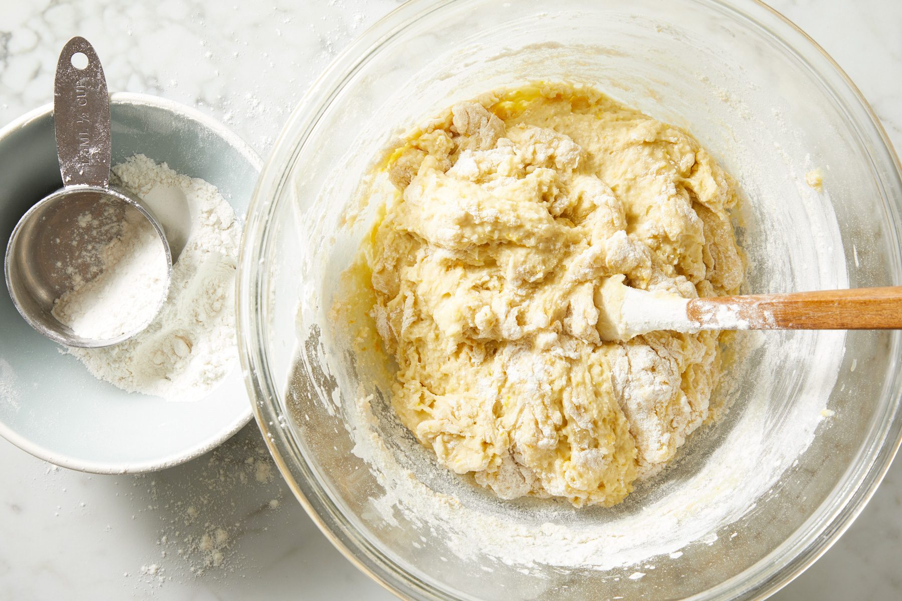 Overhead shot of stir in enough remaining flour to form a soft dough; marble surface;