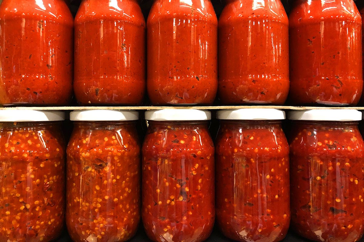 View of organic tomato paste in jars ready for winter.