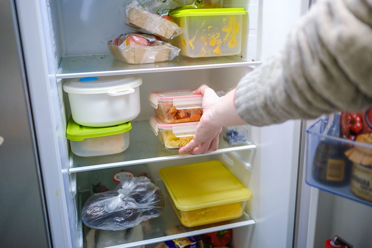 Man taking leftovers from refrigerator for dinner