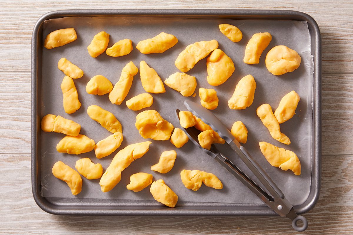 Place cheese curds on waxed paper-lined baking sheets.