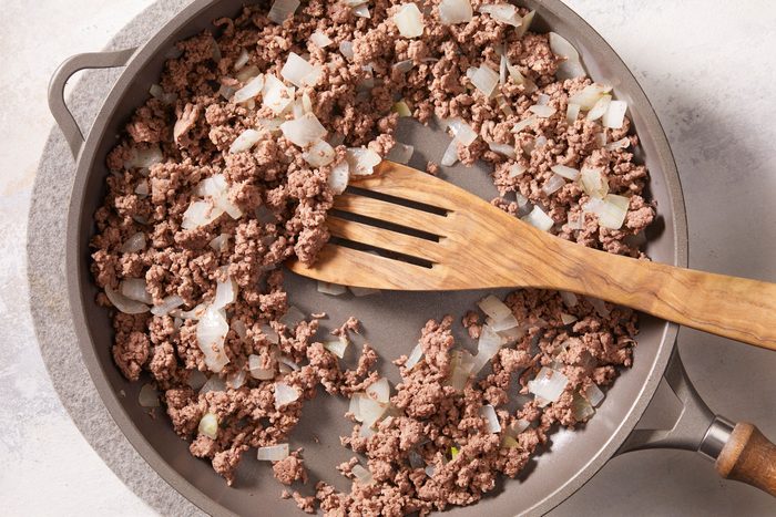 In a large skillet, cook beef and onion over medium heat until meat is no longer pink,