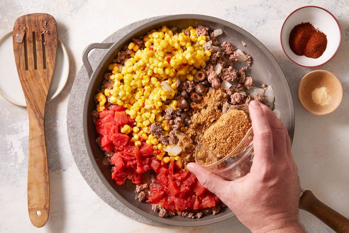 Add the tomatoes, corn, olives, taco seasoning, chili powder, salt and garlic powder.