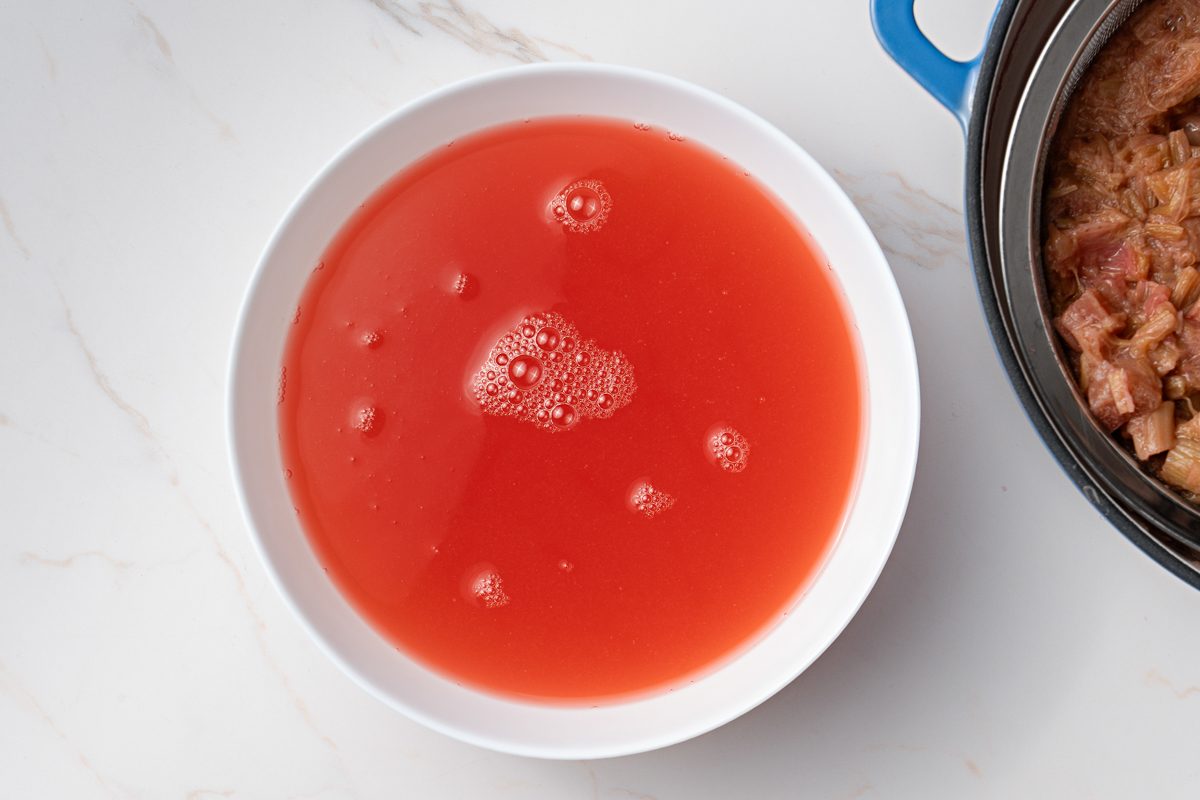 drained liquid from boiled rhubarb in a bowl
