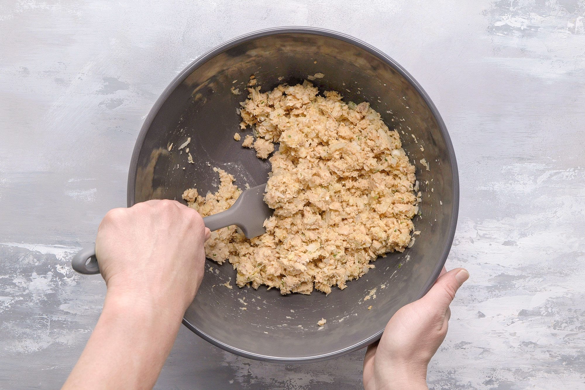 In a large bowl, combine the salmon, onion, bread crumbs and butter. Stir in the egg yolks, lemon juice, parsley, salt and pepper.