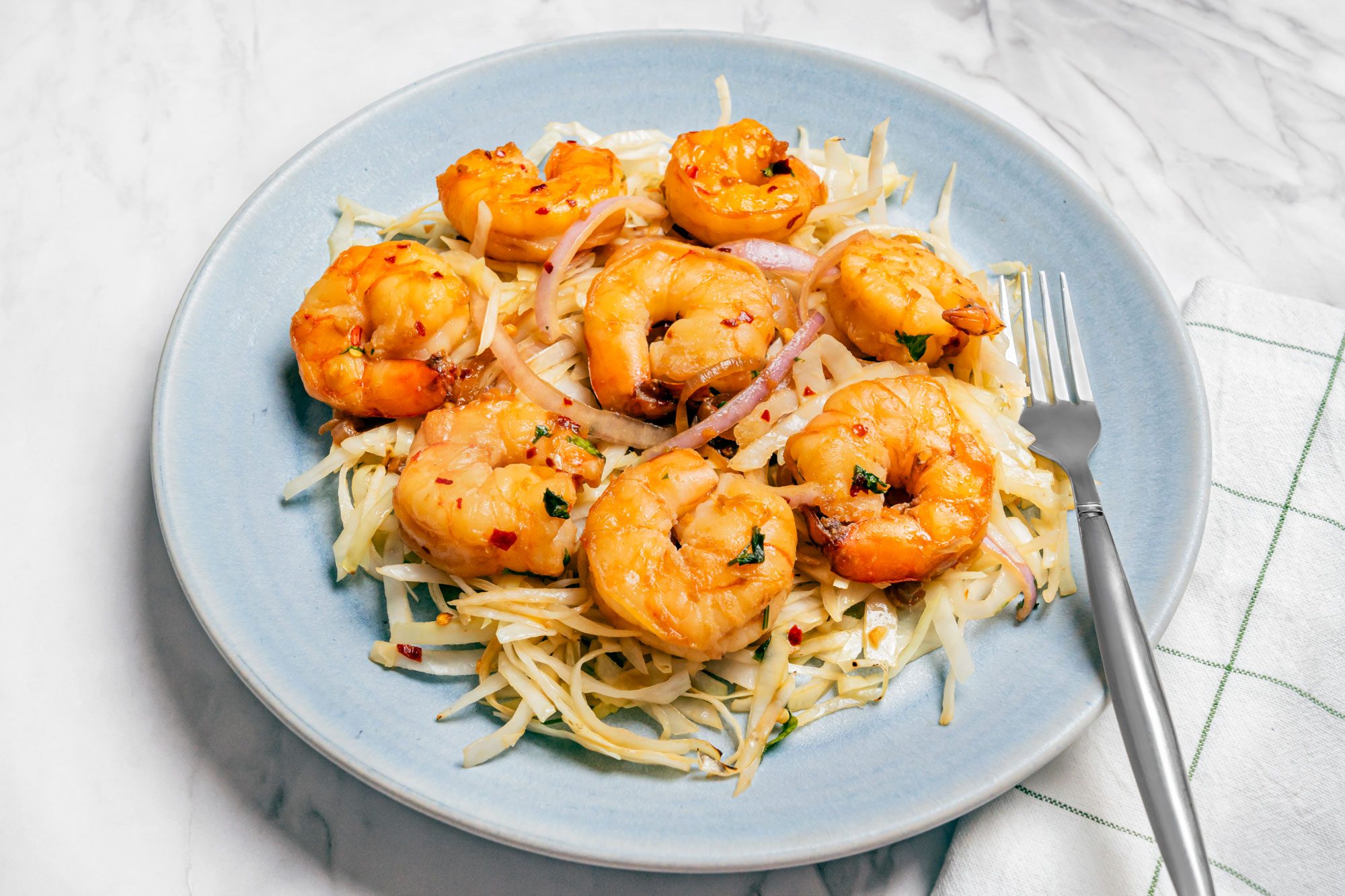 3/4 shot of Thai Shrimp served and Cabbage.