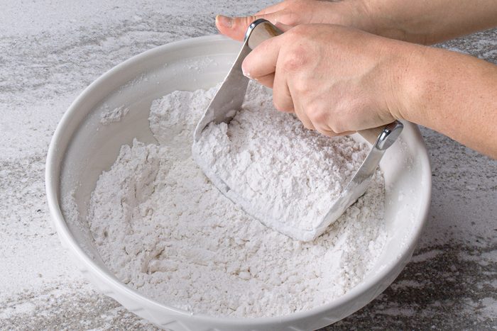 mixing flour, sugar and shortening in a bowl
