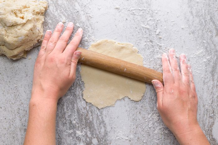 rolling dough out into 5 inch circle