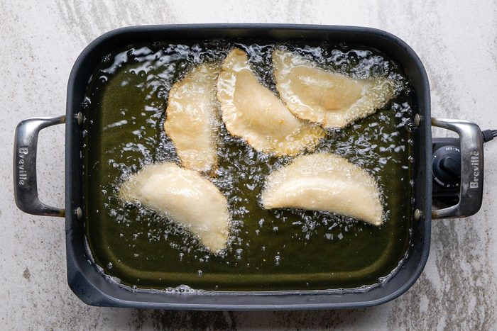 pies being fried in a skillet
