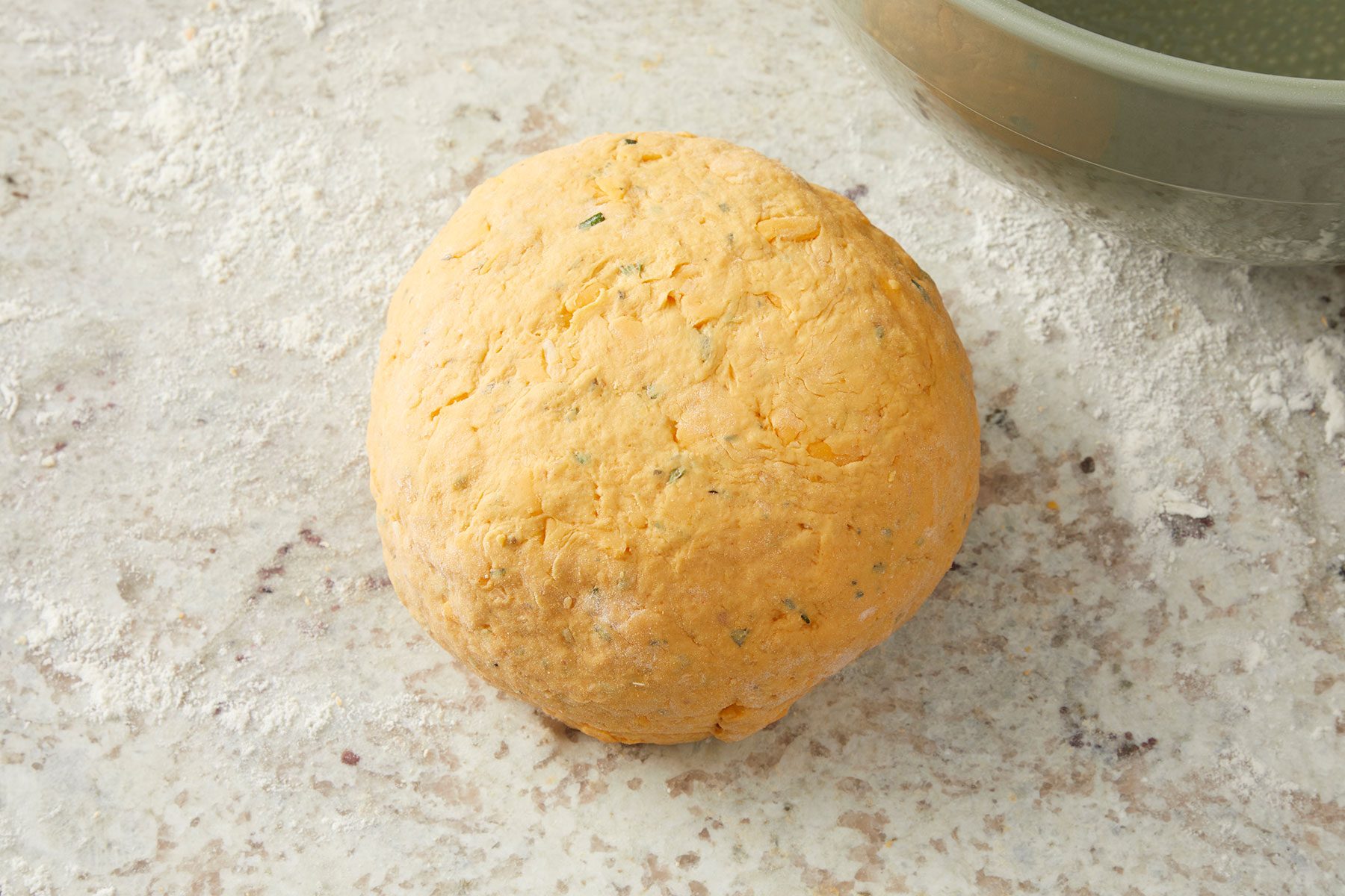 Kneaded dough ball on kitchen counter.