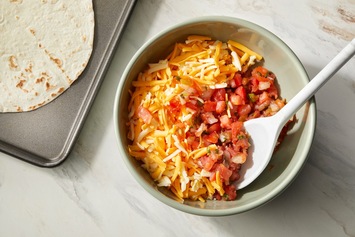 cheese and salsa stirred together in a bowl
