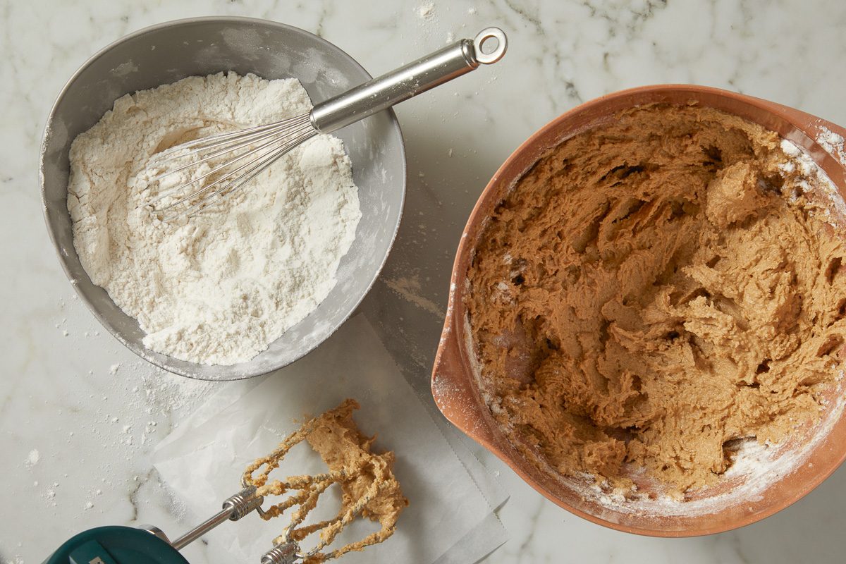 flour, baking soda and salt mixed together in a bowl next to wet ingredient mixture