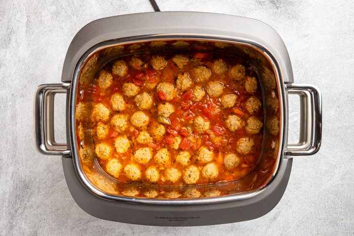 carrots, celery, onion, bay leaf, Italian seasoning, pepper, meatballs, broth, tomatoes, water and wine in a 6-quart slow cooker