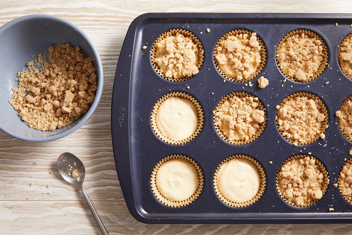 Overhead shot of muffin tin with batter topped generously with cinnamon streusel.