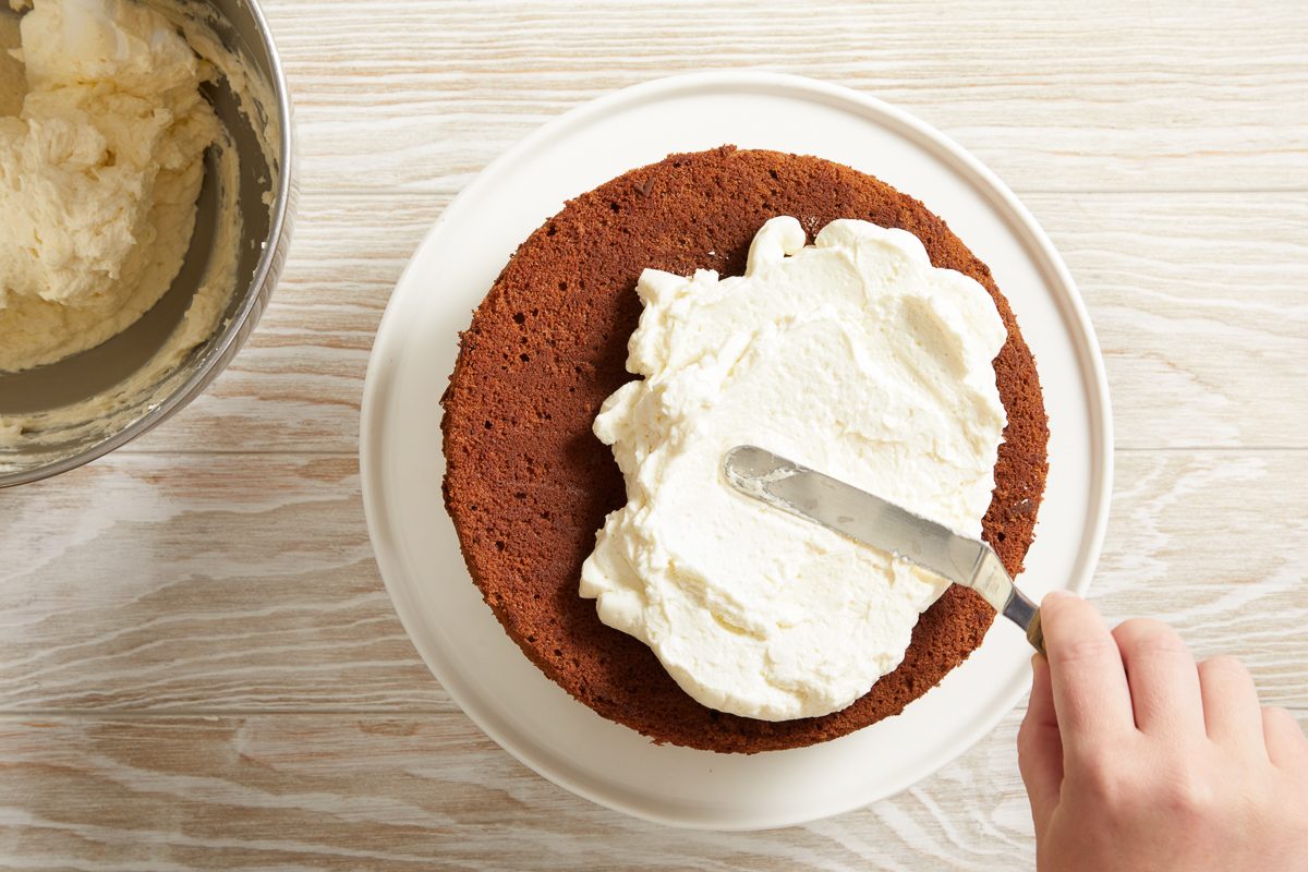 ermine frosting being spread over cake