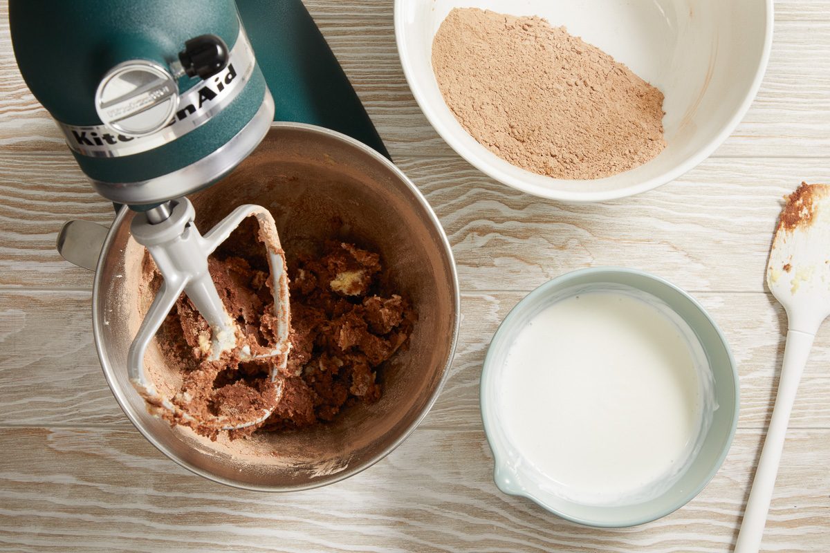 dry ingredients being mixed in with creamed mixture