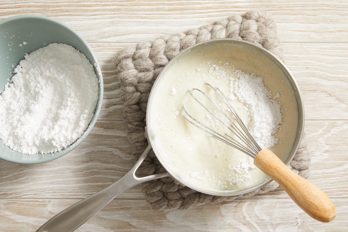 whisking flour and milk together in a heavy saucepan