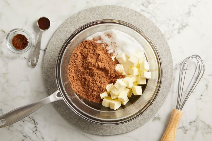 Added butter, sugar, baking cocoa and salt to the top of the double boiler.