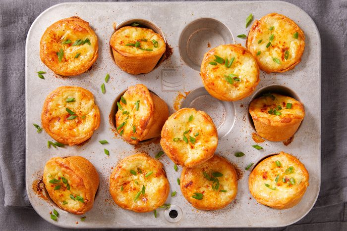 Mini Sausage Quiches in and on miniature muffin cup tray.