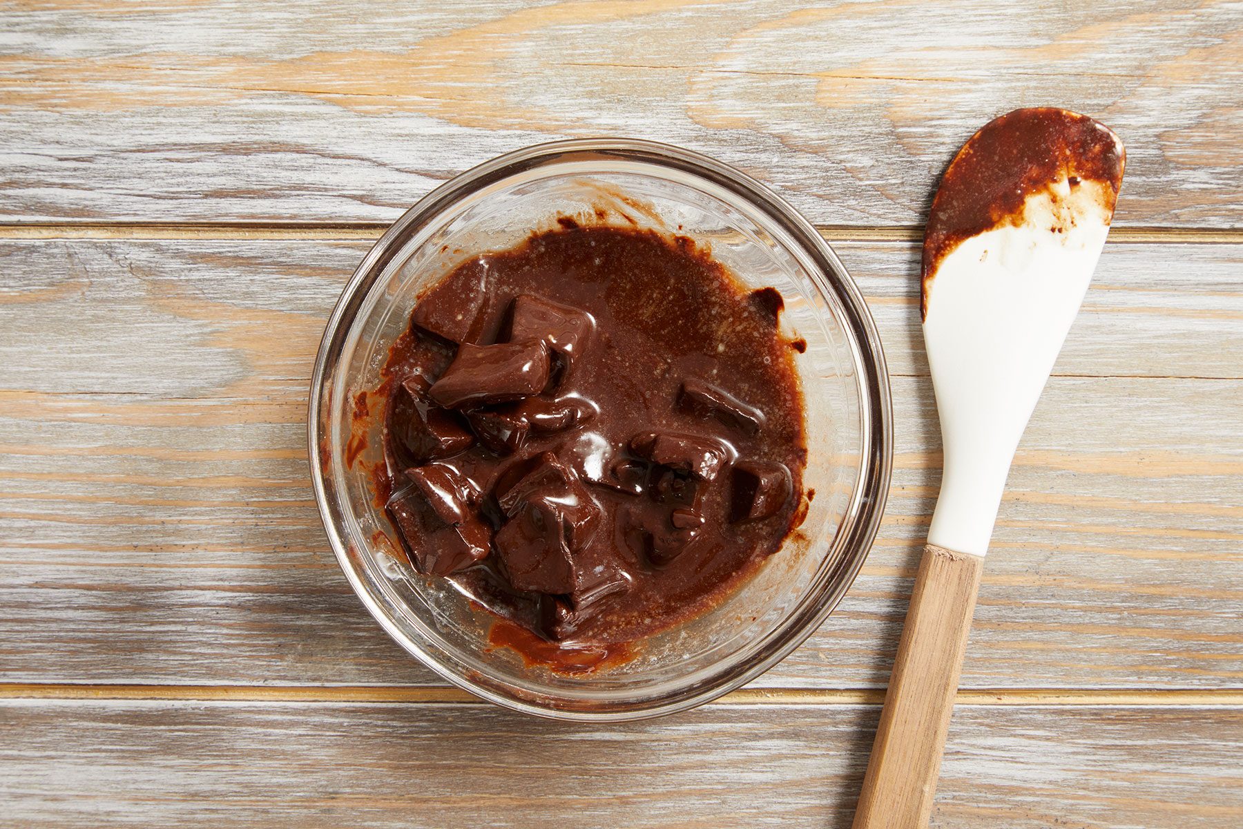 Melting unsweetened chocolate and butter and Stirring them together until they’re smooth.