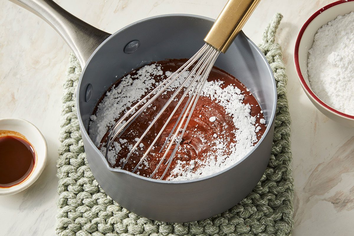 Whisking confectioners sugar into cocoa powder mixture