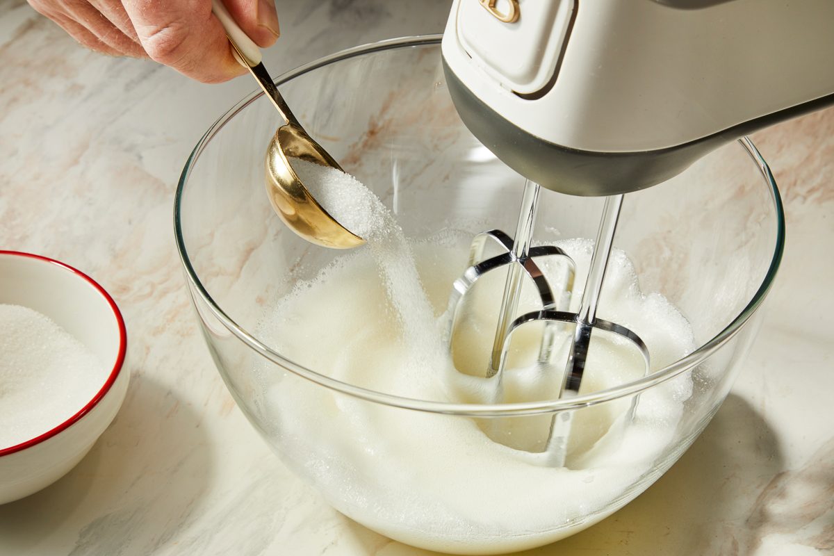 beating egg whites while adding sugar