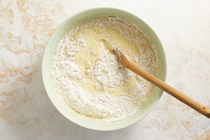 wet ingredients being mixed with dry ingredients