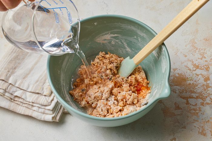 water being added to kimchi and dry ingredients