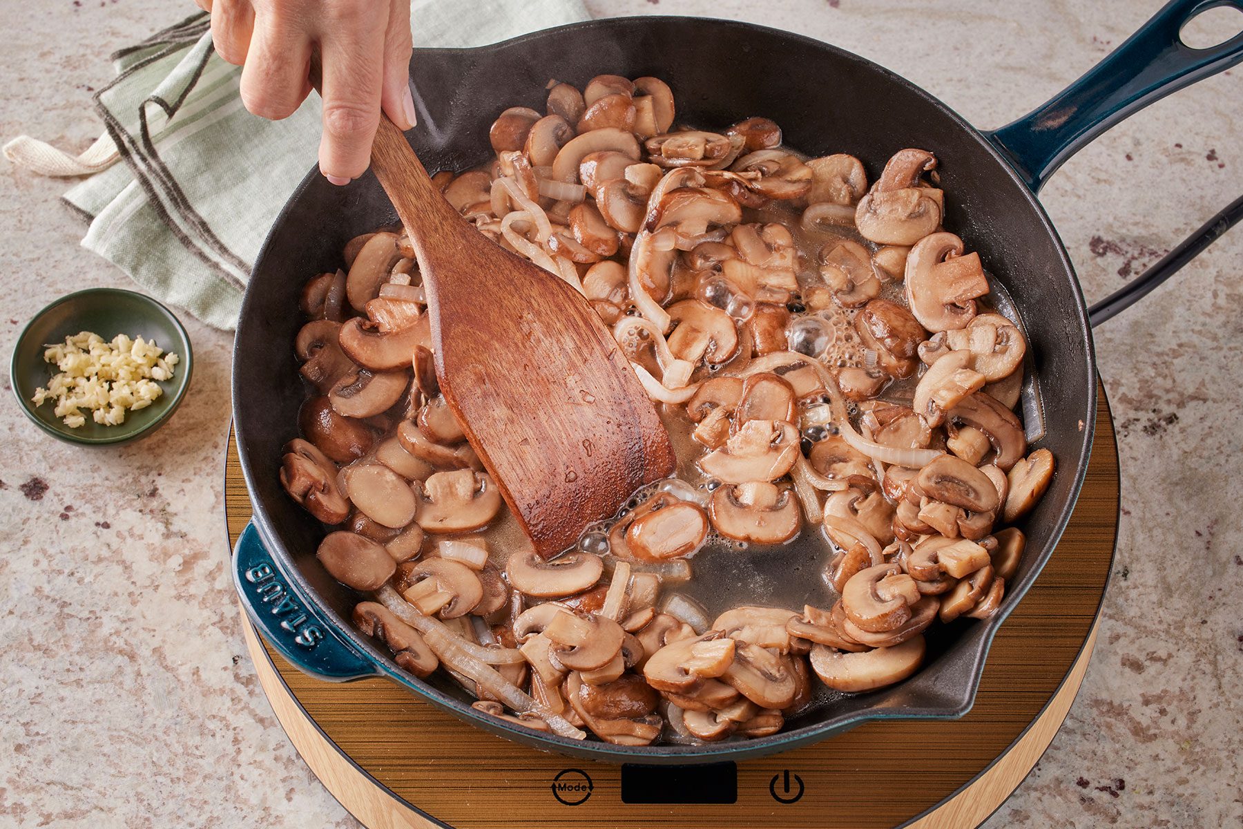 Sauté mushrooms in butter in a large skillet with chopped onions. Stirring with a wooden ladle.