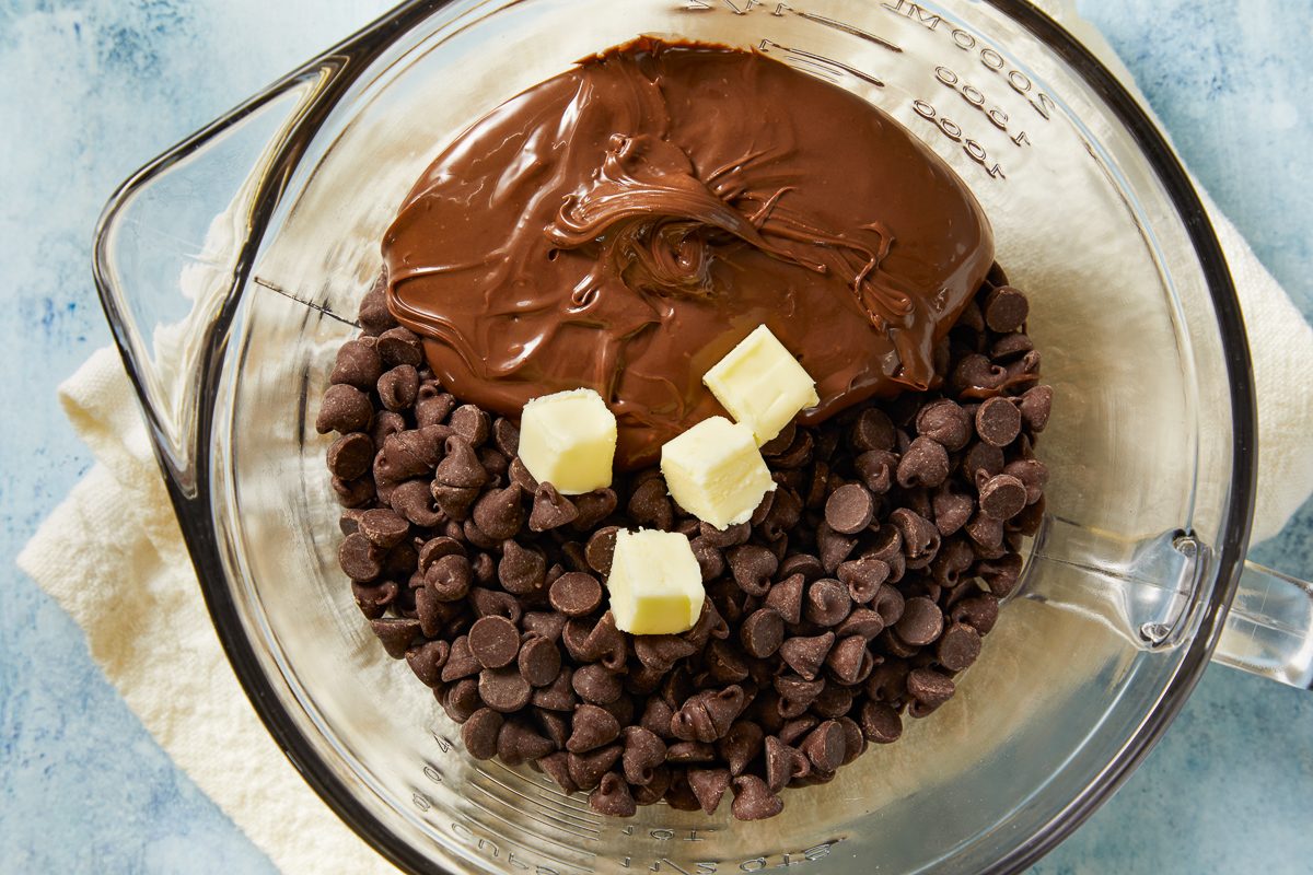 chocolate chips, Nutella and the remaining tablespoon of butter in a large microwave-safe bowl