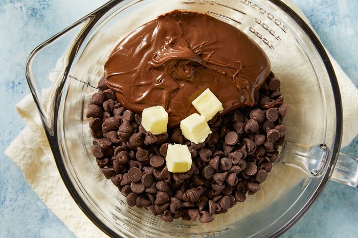 chocolate chips, Nutella and the remaining tablespoon of butter in a large microwave-safe bowl